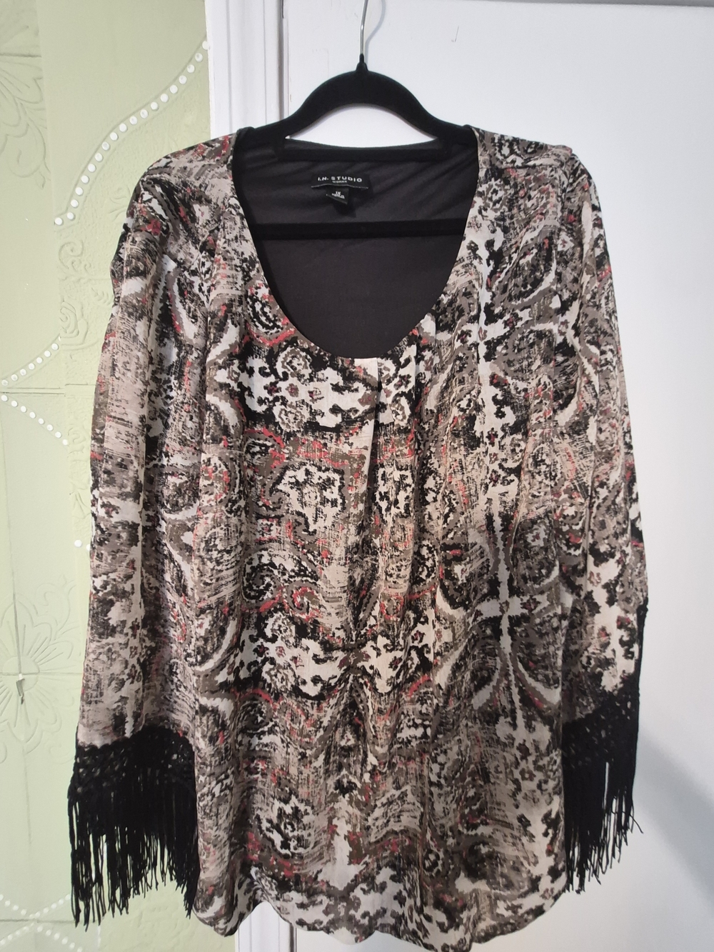 N. Studio blouse features a distinct bohemian paisley pattern with fringe detail